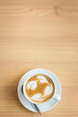 Hot art Latte Coffee in a cup on wooden table