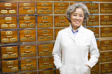 Portrait of senior doctor in traditional Chinese medicine pharmacy