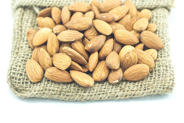 Almonds in sack isolated on white background
