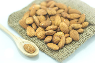 Almonds in sack isolated on white background