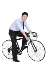 Obraz premium Cheerful young businessman on bike