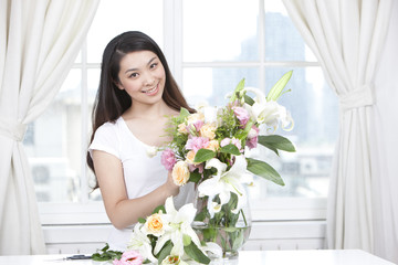 Young woman arranging flowers