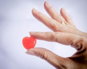 Obraz premium hand hold red heart candy