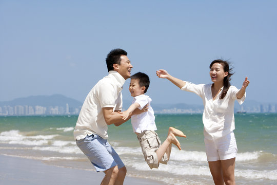 Young family playing at the beach