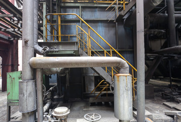 Fototapeta premium Interior of abandoned steel mill with pipes and valves.
