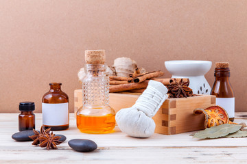 Bottle of essential oil with cinnamon stick ,star anise ,bay lea