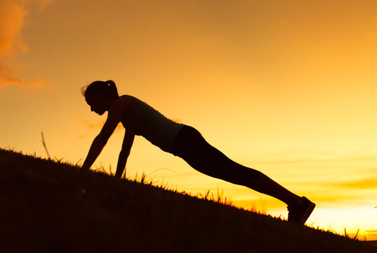 Female doing push-ups.

