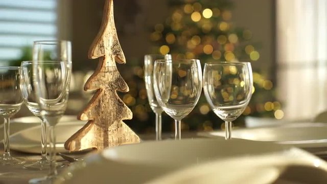 4k footage, dolly move closeup plates and glasses on table at home with christmas in background, captured with atomos shogun
