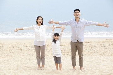 Fototapeta premium Happy young family having a good time on the beach of Repulse Bay, Hong Kong
