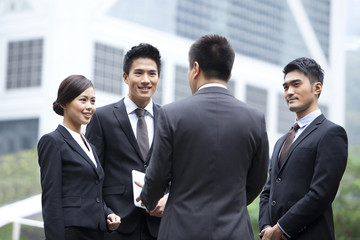 Cheerful business persons discussing with each other in Hong Kong