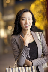 Surprised young woman with shopping bags