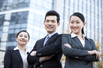 A team of businesspeople outside office buildings