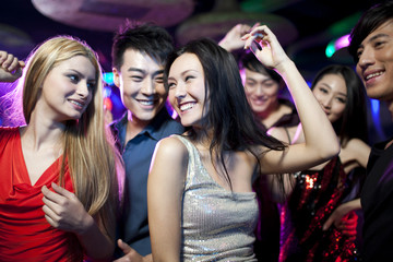 Stylish young people dancing in nightclub
