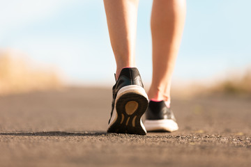 Woman walking on a path. (Fitness concept)
