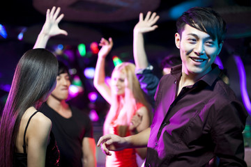 Stylish young people dancing in nightclub