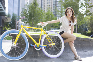 Fototapeta na wymiar Happy young woman and bicycle