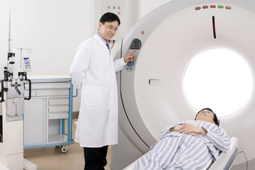  Medical professional helping a patient into a MRI scanner