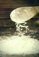 Fototapeta na wymiar Flour and wooden spoon. Tinted image.