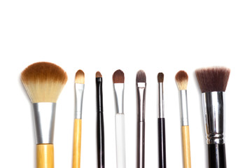 Set of makeup tools on white background with copyspace