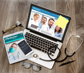 Wood doctor's desk in high definition with laptop, tablet and mo