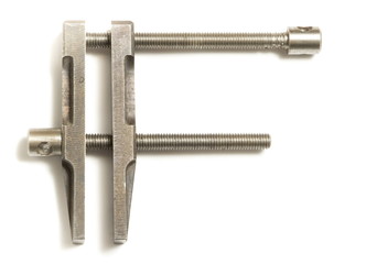 Old clamp tool on white background