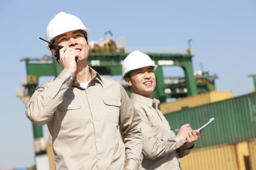 Male shipping industry workers at work