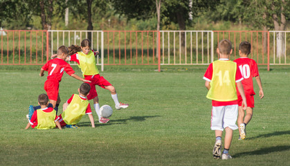 Boys kicking football