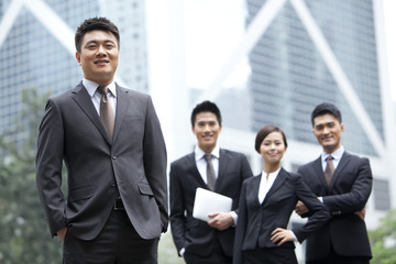 Confident businessman with his team in Hong Kong