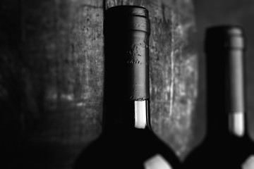 red wine bottle - tilt shift selective focus effect black and white photo
