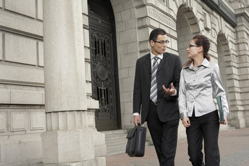 Businessman And Businesswoman Talking To Each Other