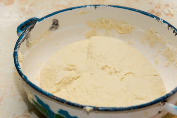 Prepared dough in a metal bowl