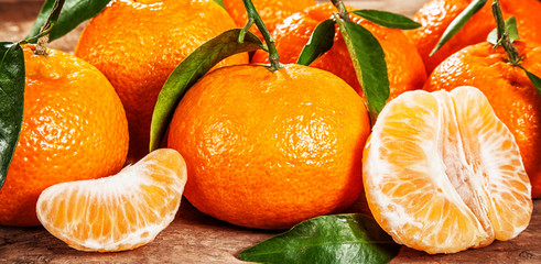 Fresh juicy tangerines with green leaves