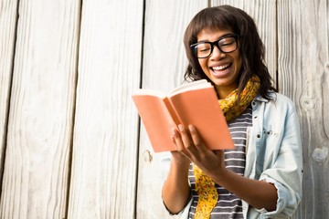 Smiling casual woman reading a book