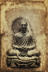 Fototapeta na wymiar Vintage sepia toned seated Buddha statue