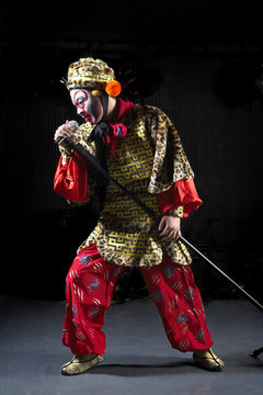 Man In Ceremonial Costume With Microphone