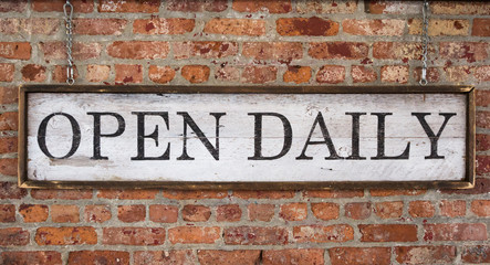 Wooden sign with text open daily