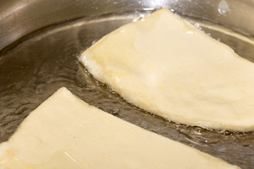 Frying puff pastry in hot oil
