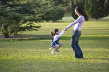 Fototapeta premium Mother and daughter playing in the park