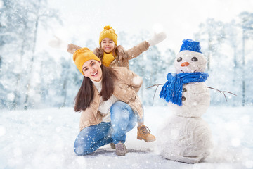 Mother and child girl on a winter walk