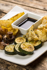 Roasted vegetables with sauce on the table