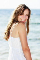 Fototapeta na wymiar Young happy woman near the sea