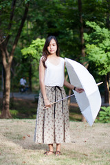 woman with umbrella in a park