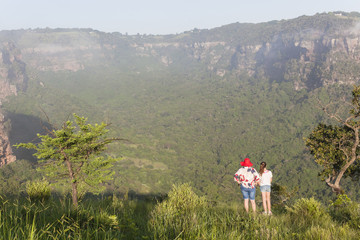 Obraz premium Girl Hiking Wilderness overlooking rural valley landscape summer.