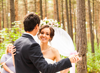 The newlyweds dancing near the wedding arch 