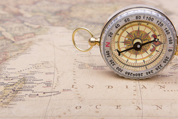 Fototapeta na wymiar Old compass on vintage map