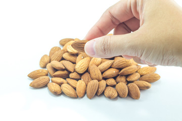 Hand on almond grain isolated on white background