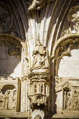 arch with figures of Gothic style cathedral in Toledo Spain