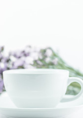 White mug cup and static flower