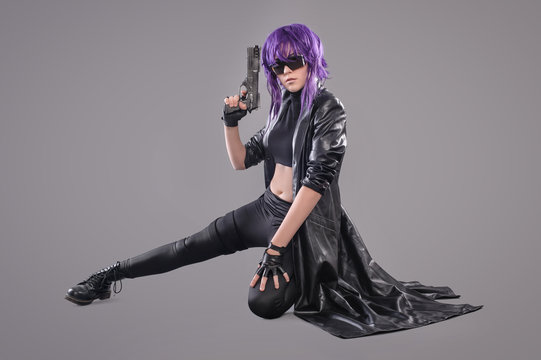 Woman with gun / Portrait of sexy woman posing in studio with gun