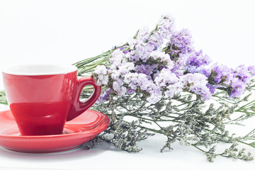 Red cup of cofee and static flower
